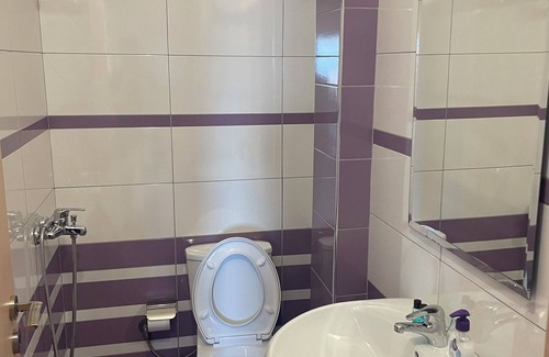 Sarande Apartment | The apartment has a beautiful view of the city and the sea with a balcony.