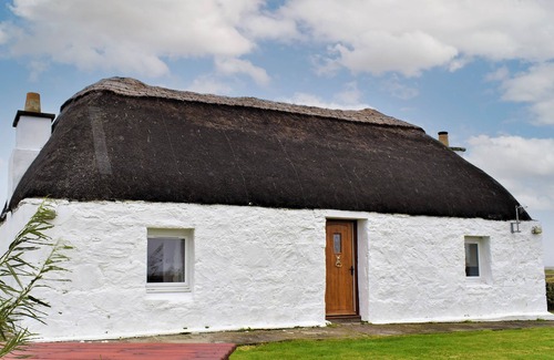 Benbecula Cottage | The cottage is so attractive with its traditional thatch and whitewashed walls.