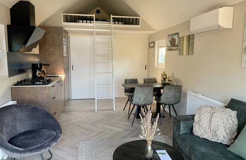 Lathum House | Tiny house time out at the lake and beach. Fenced garden, outdoor shower and fireplace.