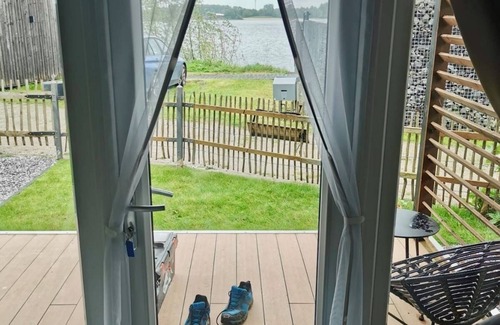Lathum House | Tiny house time out at the lake and beach. Fenced garden, outdoor shower and fireplace.