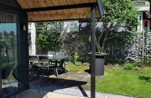 Lathum House | Tiny house time out at the lake and beach. Fenced garden, outdoor shower and fireplace.