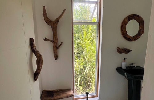 Epworth Apartment | Tropical Sanctuary, with private garden, hanging seats and fire pits.