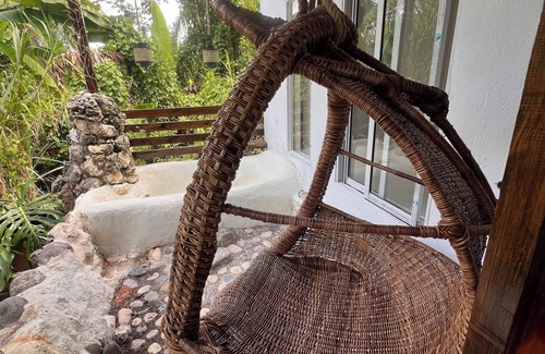 Epworth Apartment | Tropical Sanctuary, with private garden, hanging seats and fire pits.