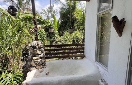 Epworth Apartment | Tropical Sanctuary, with private garden, hanging seats and fire pits.