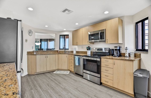 Sand Key Condo | Vibrant, ocean-view condo with hot tub, tennis court, pool, W/D, balcony & grill