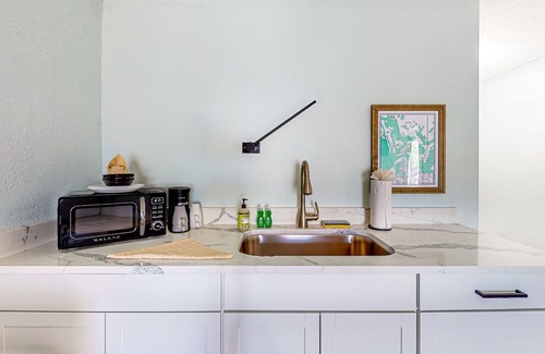 Isles of Capri Condo | Water-view Marco Island condo with firepit, grill, dock & W/D access