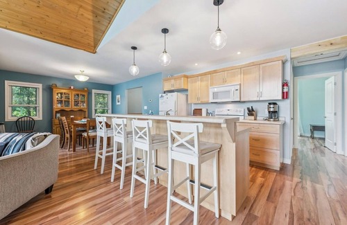 Miller Lake Cottage | Watersedge: 4BR Miller Lake cottage with dock, firepit, decks, spacious interiors, rec room & foosball.