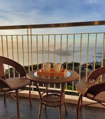 1 BR Cozy Farmhouse-Style Condo with Balcony & Taal View at Wind Residences
