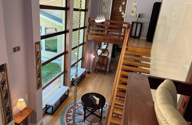 5-Bedroom 6000SF wood and glass retreat in Atlanta, surrounded by greenery.