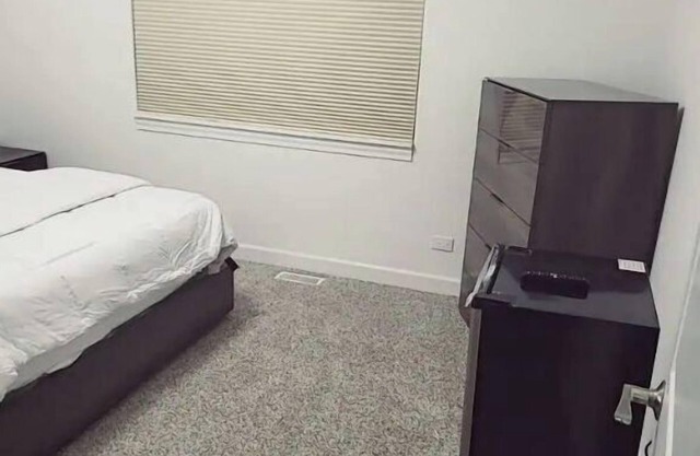 A cozy bedroom in a home with high-tech amenities