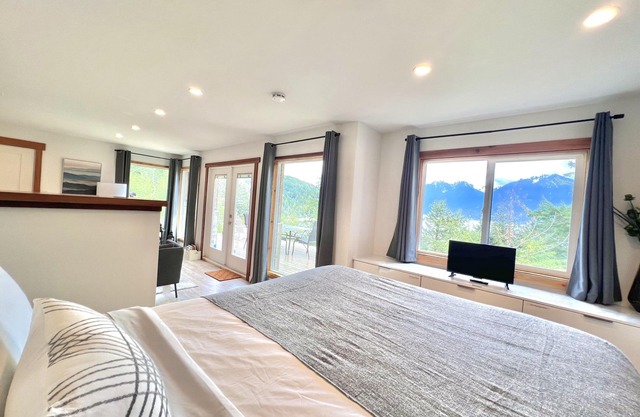 A cozy guest suite with a panoramic ocean view facing the Howe Sound Mountain