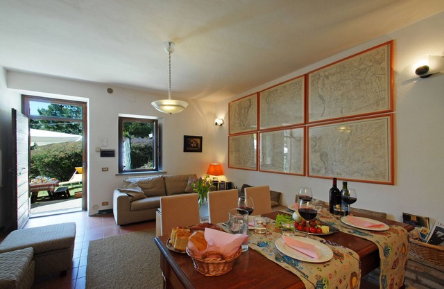 A farmhouse in a large forest on a mountain with an immense view around it.