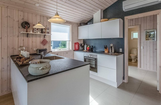 Beautiful cottage with kitchen open connection with dining and living room with an alcove.