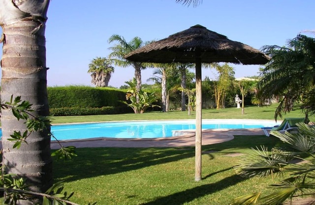 Bungalow with pool, gardens and lake.