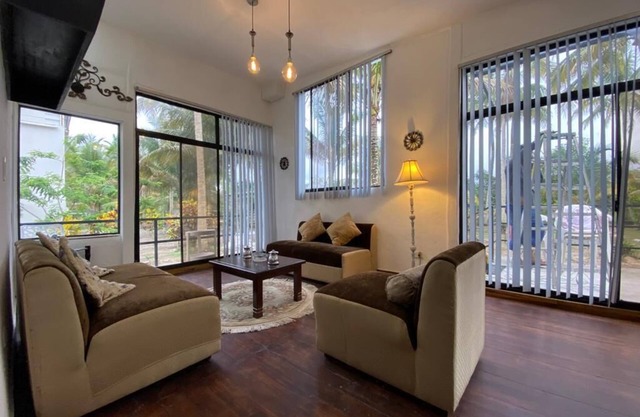 Comfortable villa between palm trees facing the sea.