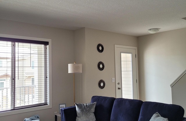 COZY 2-BR TOWNHOUSE. Private ATTACHED GARAGE and BALCONY. Near YQR AIRPORT.