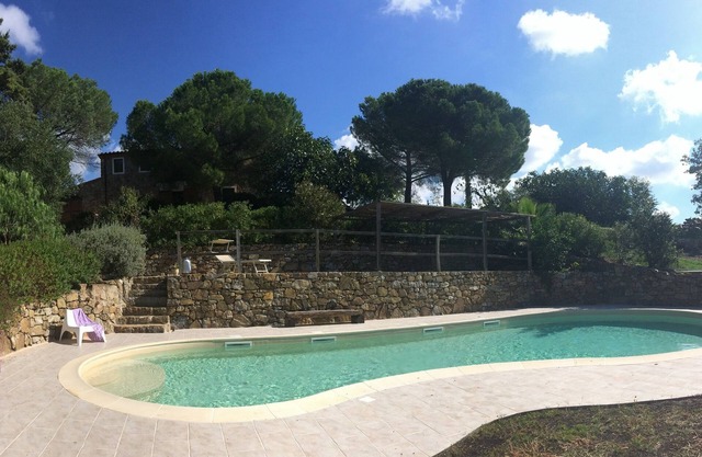 Cozy tuscan casale in stone and wood on a top of hill covered with olive trees