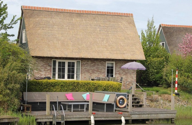 Detached luxury villa with a terrace and jetty next to open waters