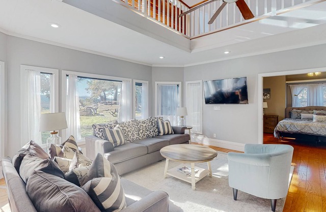 Gorgeous water view home with a fireplace, outdoor space & central AC