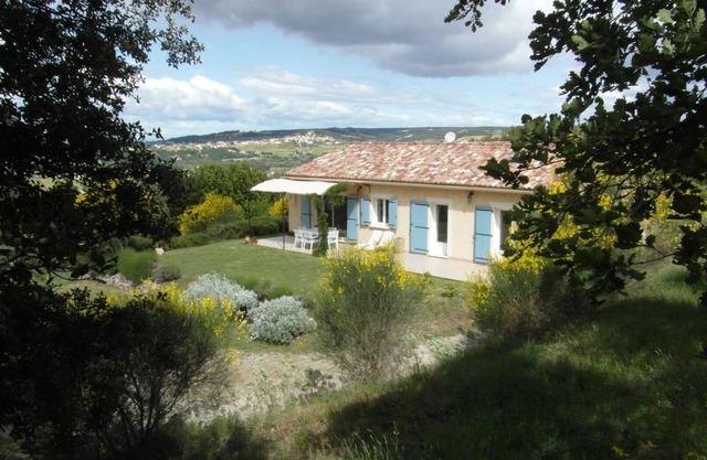 House on the hills of Provence overlooking vineyards .