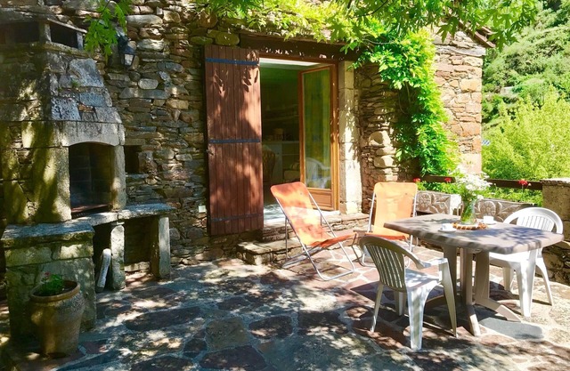 In a fantastic medieval village, house in stone with a nice view near the river