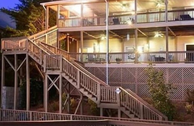 Lakefront sunset mtn view outdoor oasis, with waterslide and diving board.