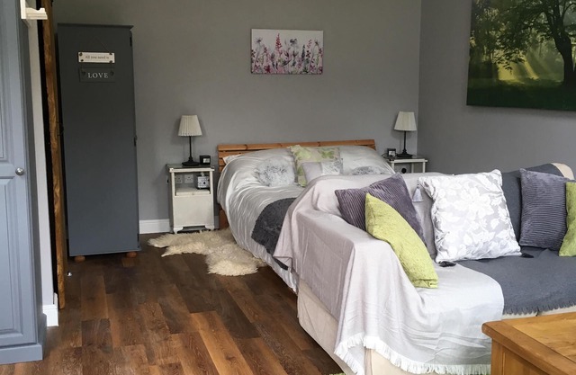 Lovely Wooden Lodge, views over an orchard, outside seating.