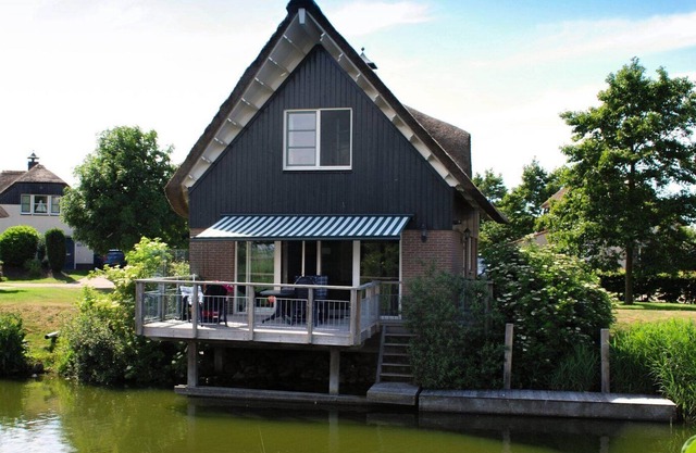Luxurious detached villa with patio above the water