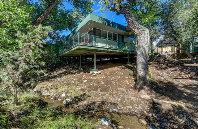Modern cabin hidden among the trees- Unwind and relax on the porch creek-side.