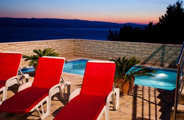 Modern vacation apartment with pool and sea view