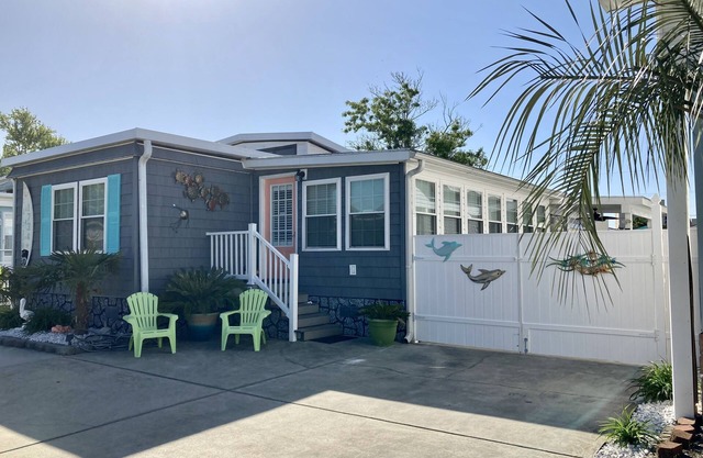 One minute drive to beach with golfcart! Updated, beach decor & clean!