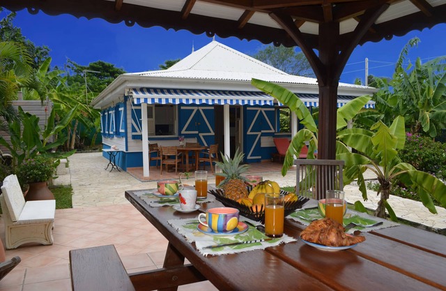 Pretty, old Creole villa with veranda, gazebo and floral garden.