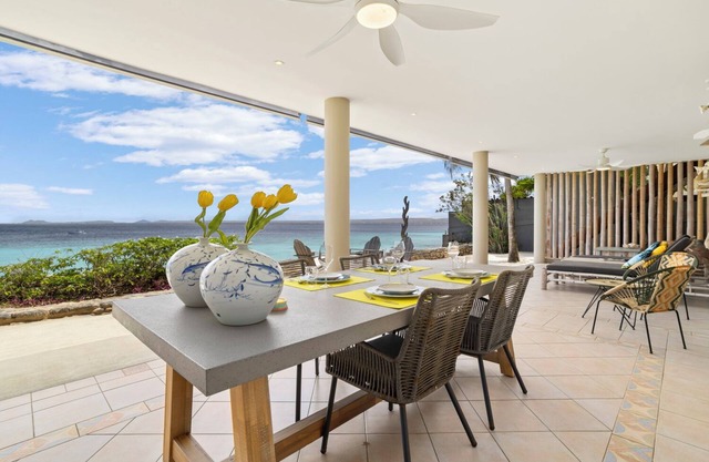 Romantic oceanfront studio in Bonaire with private porch and sea views. Perfect for couples seeking peace, privacy, and tropical charm.