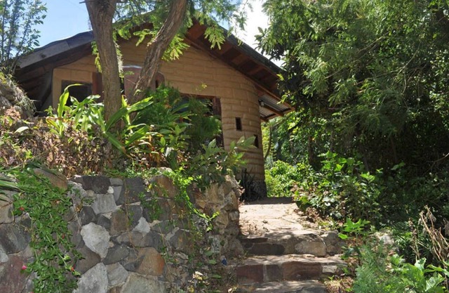 secluded adobe earth and wood house.