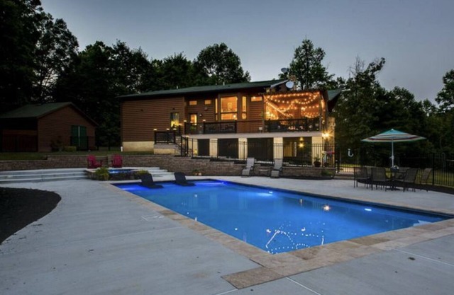Secluded log cabin home located on 13 acres with salt water pool & jacuzzi.