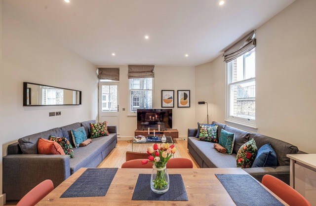 Spacious first-floor apartment with lift access on Great Titchfield Street. Sleeps 18 with 3 bedrooms, 3 living rooms, 3 kitchens, and 3 bathrooms. Steps from Oxford Street and Soho.