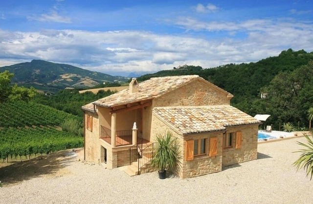 Spectacular views across the pool to mountains and historic village.