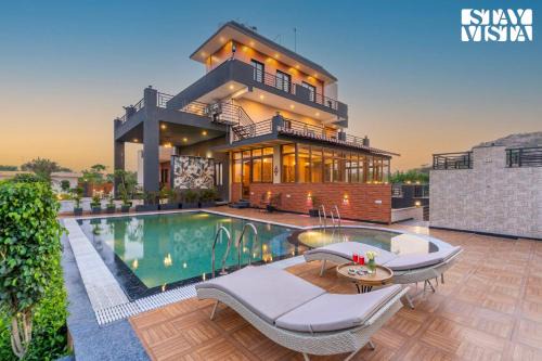 StayVista's Shivoham Farms - Mountain-View Villa with Outdoor Pool, Lawn, and Terrace