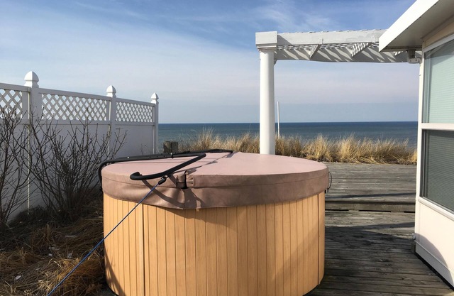 Stunning Lake Michigan views in our light, airy beachfront cottage. Sleeps 10.