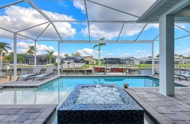 Stunning New Waterfront Luxury Villa with oversized Heated pool and Hot tub!