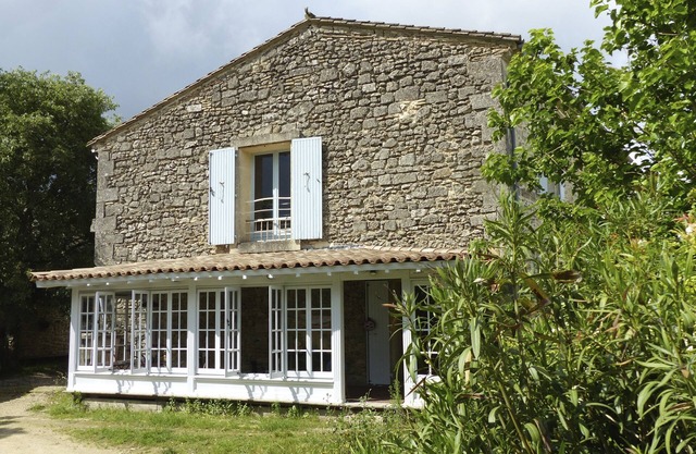 Superbly equipped apartment in old stone house with large pool and great view.
