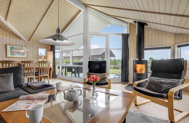 The cottage has an inviting kitchen-living room with a fireplace and a partially covered terrace.