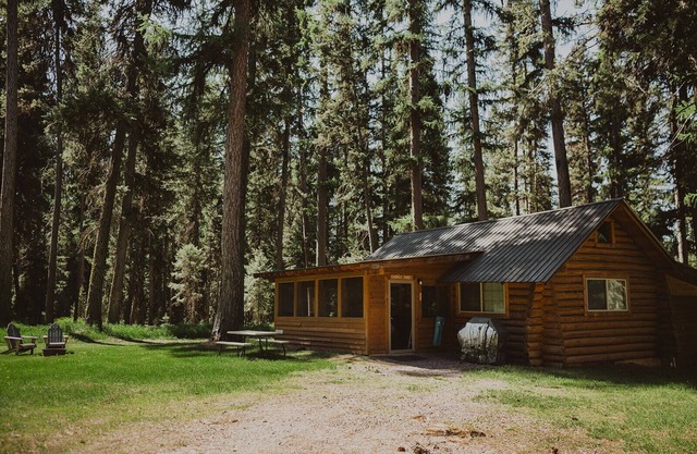 The Saddle Shed at Tamaracks Resort is a log cabin with furnished screen porch.
