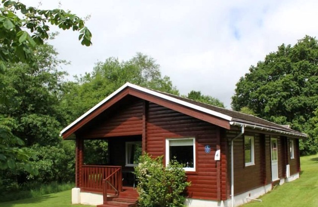 Traditional Log Cabin At Puck's Glen In The Argyll Forest Park