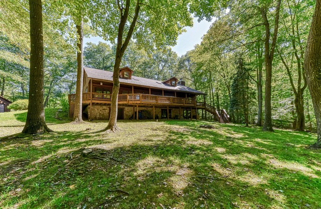 Updated cabin with private hot tub, wraparound deck & forest view - dog-friendly