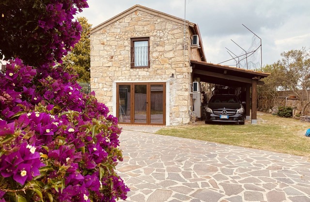 Villa with garden, large windows, exposed beams and stones