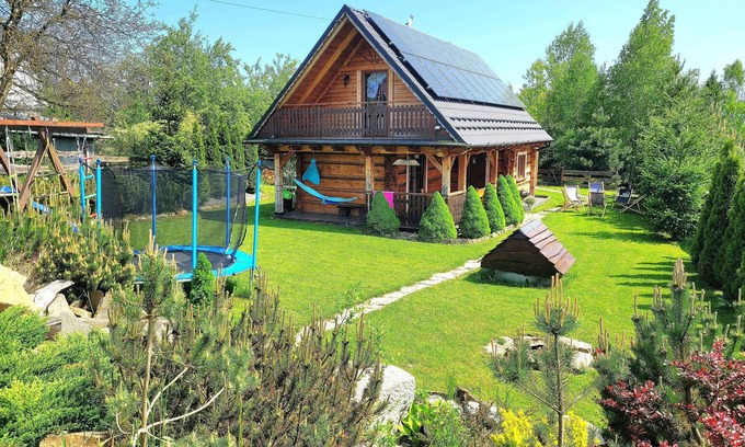 Raba Wyzna House | A beautiful wooden house with a sauna and jacuzzi and a large garden.