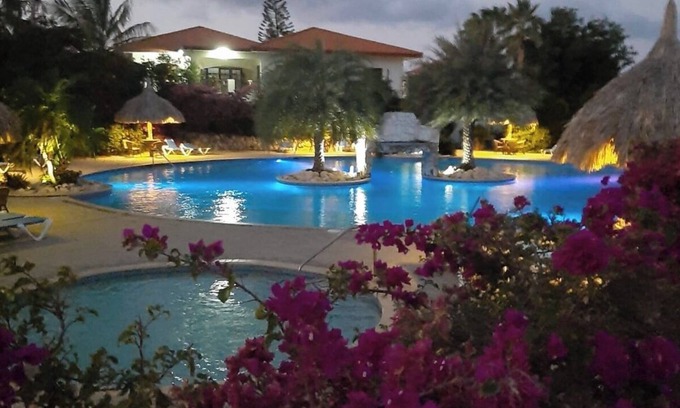 Santa Rosa Condo | A small mansion with a large swimming pool in a botanical garden