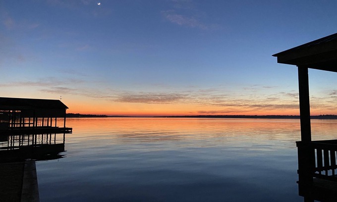 Dogwood House | Amazing sunsets at a lake front luxury home.