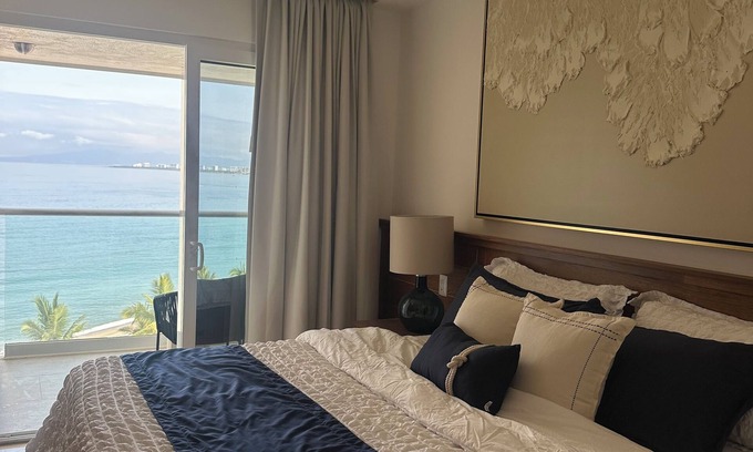 Las Glorias Apartment | Beachfront Studio with Balcony, Rooftop Pool & Gym Access